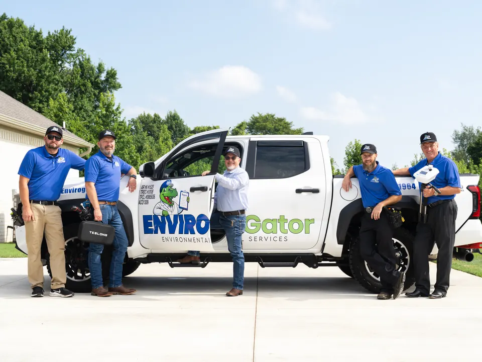 The EnviroGator inspection team standing beside their company truck
